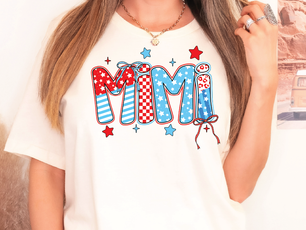 a woman wearing a white shirt with the word mom printed on it