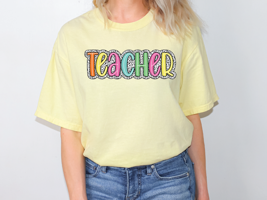a woman wearing a yellow tshirt with the word teach on it