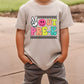 a young boy wearing a t - shirt with a peace sign on it