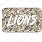A camouflage-patterned rectangular object with the word "LIONS" written in bold white letters.