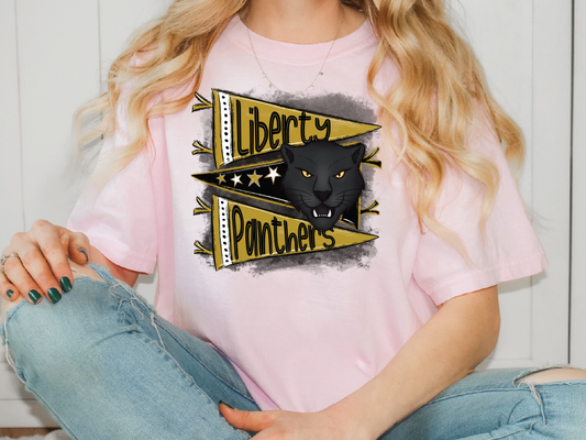 A woman wearing a pink t-shirt with a graphic design featuring a black panther and the text "Liberty Panthers".
