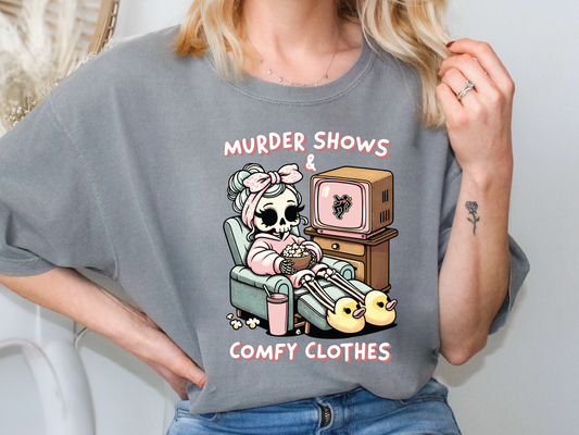a woman wearing a t - shirt that says murder shows comfy clothes