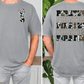 a man wearing a gray t-shirt with a camouflage pattern and the text "PIRATES PIRATES PIRATES" printed on the back.