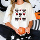 a woman sitting on a bed holding a pumpkin mug