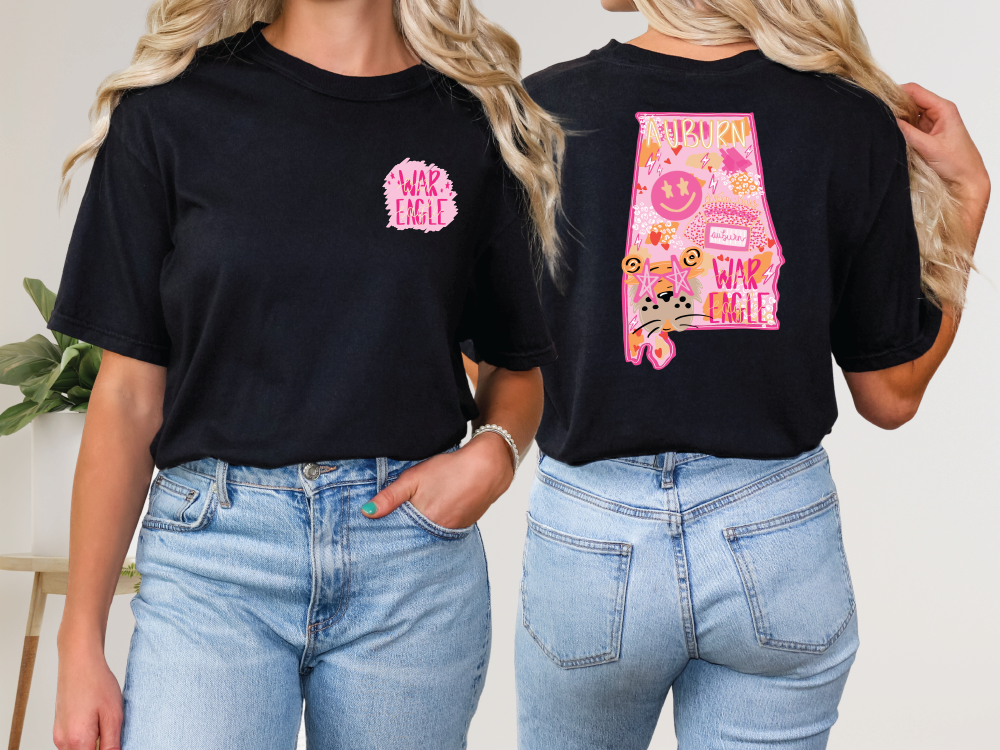 two women wearing black shirts with pink letters on them