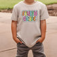 a young boy wearing a t - shirt that says hello god