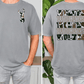 a man wearing a gray t-shirt with a graphic design featuring a deer head and the word "Wolves" repeated in a pattern across the back.