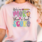 a woman wearing a pink shirt that says you're more than a test score