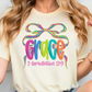 A woman wearing a white t-shirt with a colorful graphic design featuring the word "Grace" and a ribbon.