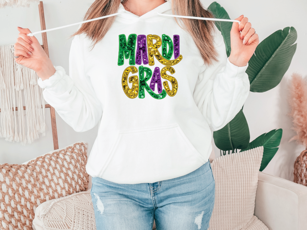 a woman holding a string with mardi gras on it