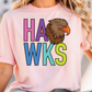 A woman wearing a pink t-shirt with the text "HAWS" printed on it, along with an illustration of a hawk.