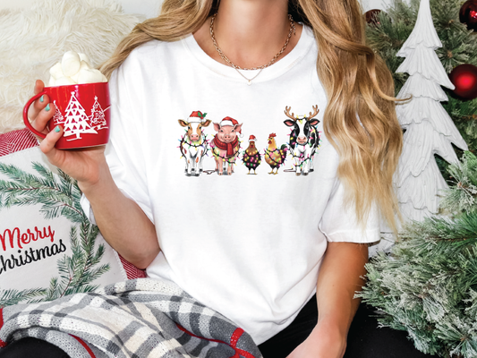 a woman holding a cup of coffee in front of a christmas tree