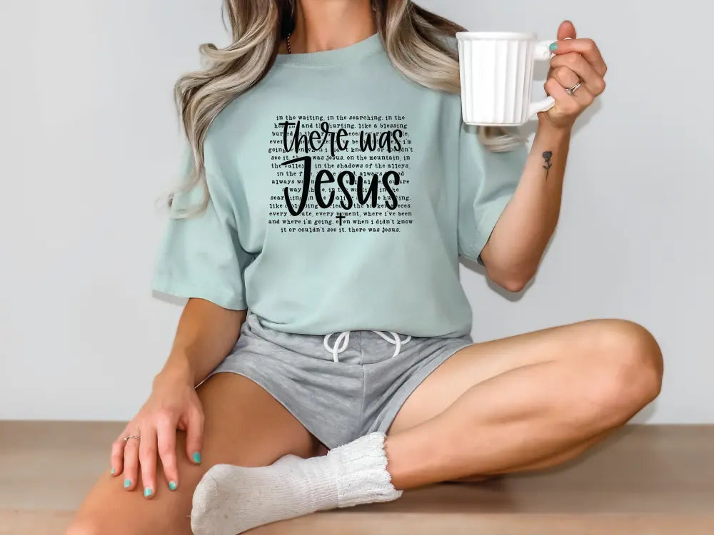 a woman sitting on the floor holding a cup of coffee