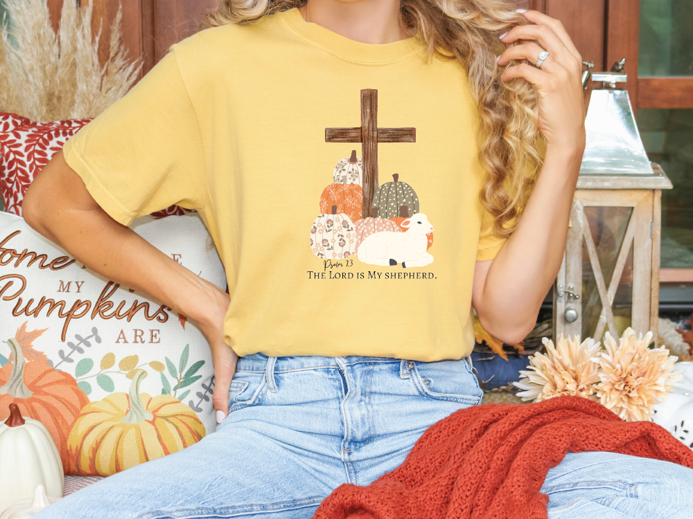 a woman sitting on a couch wearing a yellow t - shirt