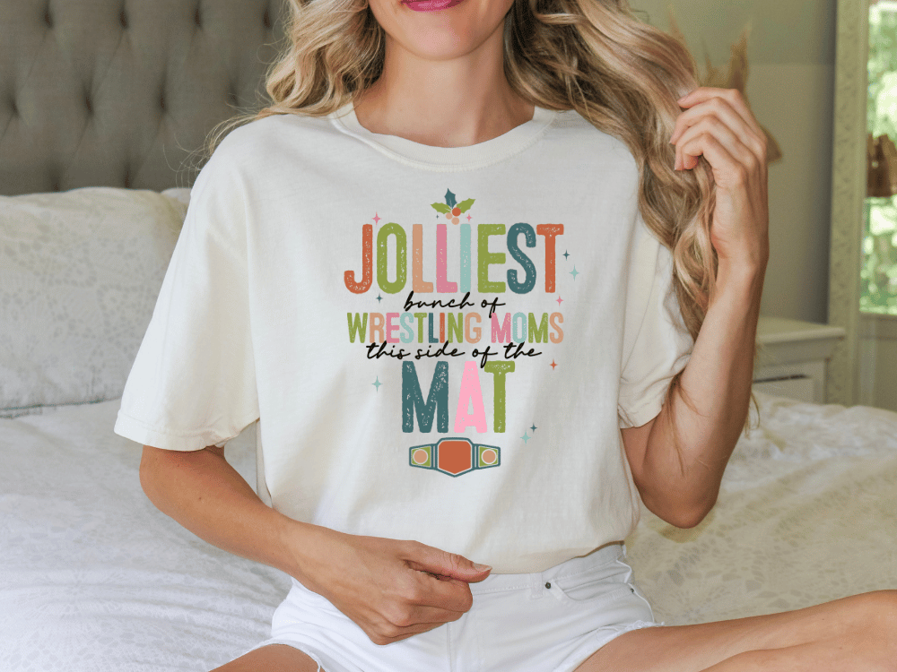 A woman wearing a white t-shirt with a colorful graphic design and text on it.
