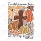 a cross surrounded by flowers and pumpkins