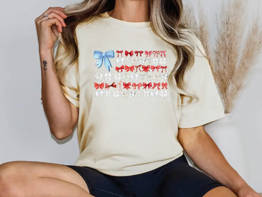 a woman sitting on a chair wearing a t - shirt with bows on it