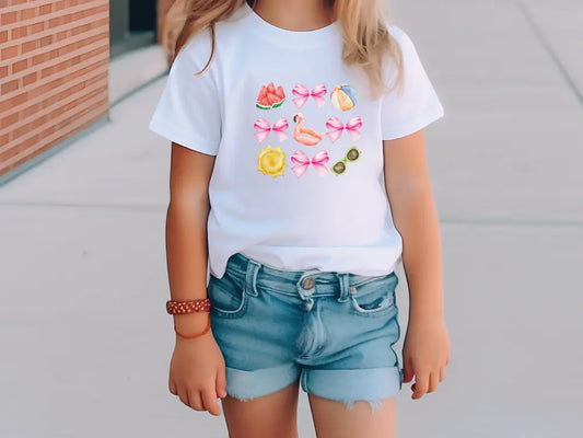 a little girl wearing a t - shirt with flowers on it