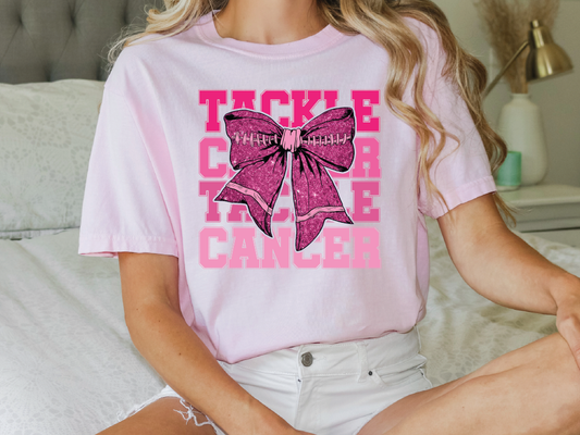 a woman sitting on a bed wearing a pink shirt