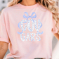 A woman wearing a pink t-shirt with the word "COUGARS" printed on it.