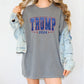 a woman wearing a gray shirt dress with the word trump printed on it