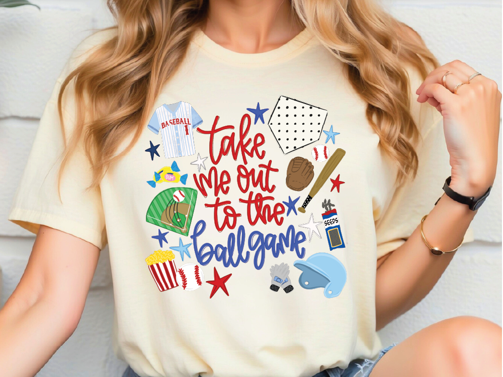 A woman wearing a white t-shirt with a graphic design featuring various baseball-related items such as a baseball jersey, baseball bat, and baseball.