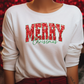 a close up of a person wearing a merry christmas shirt