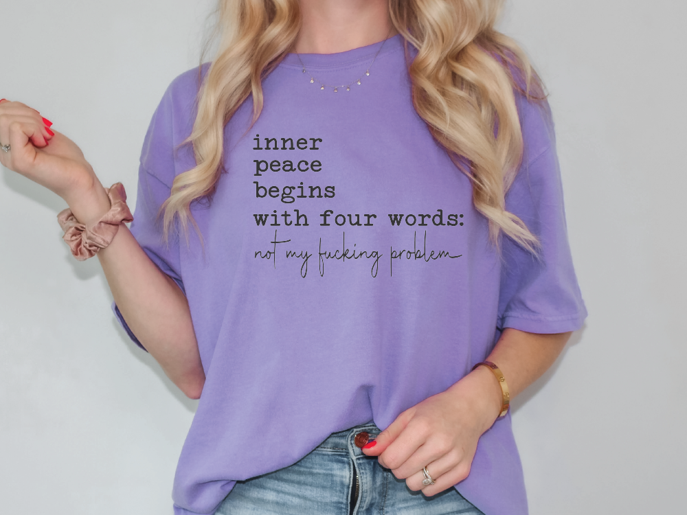 a woman wearing a purple shirt that says inner peace begins with four words