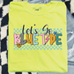A yellow t-shirt with the text "LET'S GO BLUE TYPE" printed on it, along with various colorful and stylized graphics.