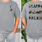 a man wearing a gray t-shirt with a graphic design on the front and back.