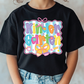 a little girl wearing a black shirt that says kind of pretty