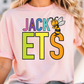 A person wearing a pink t-shirt with the text "JACK ETS" printed on it, along with a cartoon bee graphic.