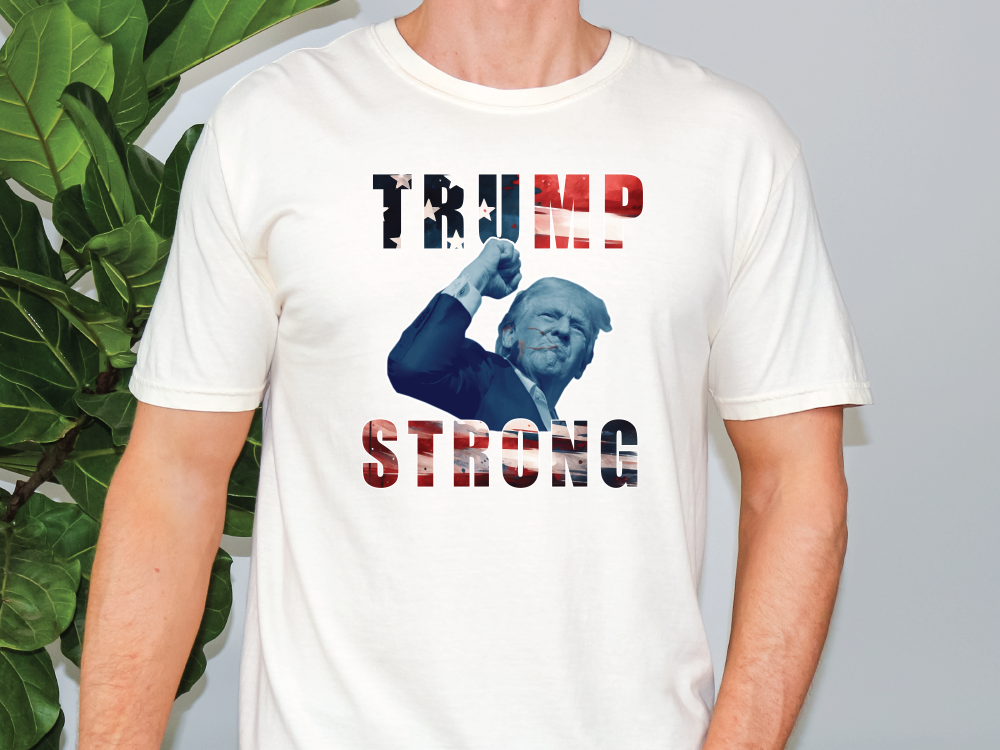 a man wearing a trump t - shirt with the words trump strong on it