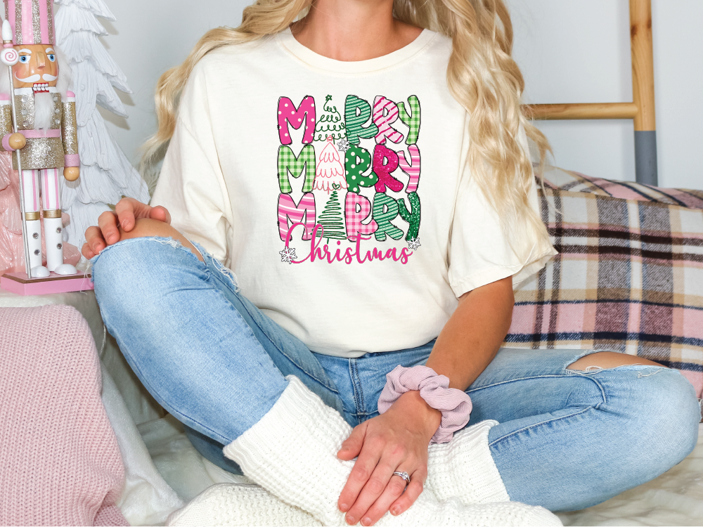 a woman sitting on a couch wearing a merry christmas t - shirt