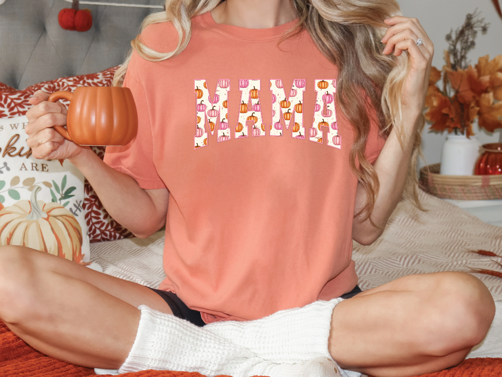 a woman sitting on a bed holding a pumpkin