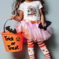 a little girl in a halloween costume holding a trick or treat bucket