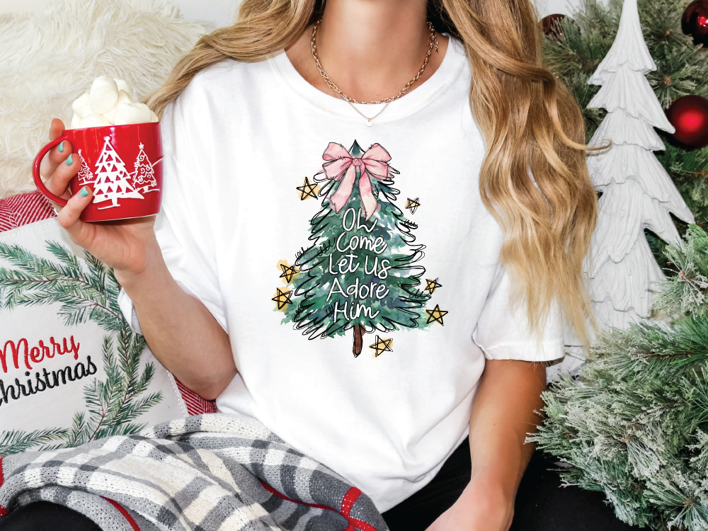 a woman holding a cup of hot chocolate in front of a christmas tree