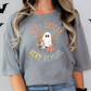 a woman wearing a grey shirt with a ghost on it