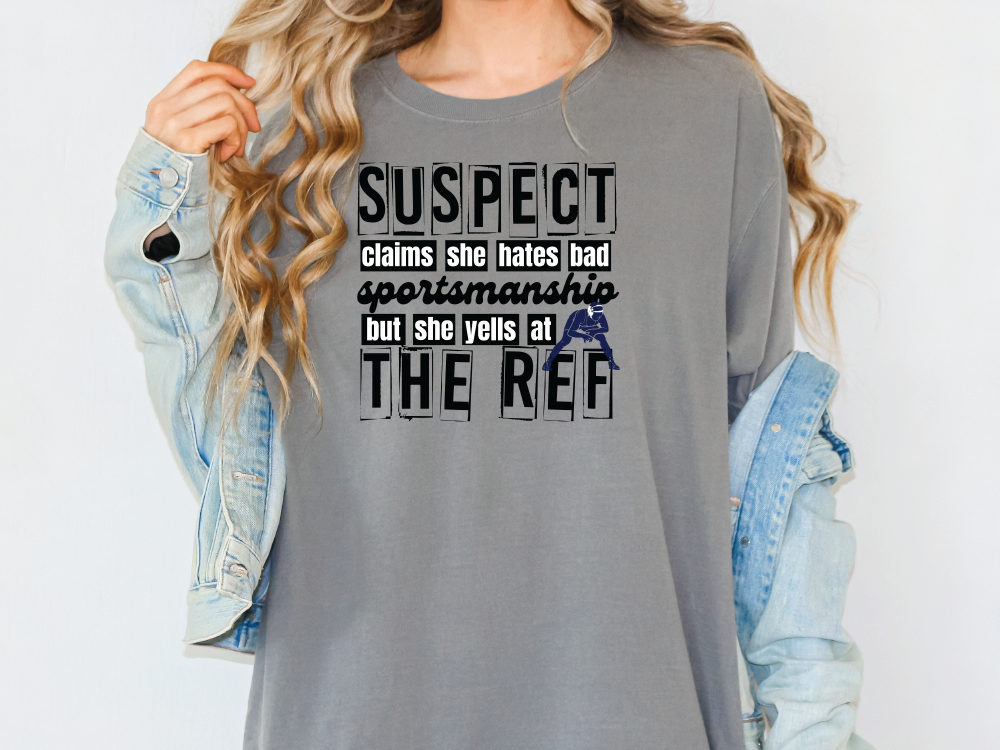 a woman wearing a grey shirt that says suspect against the ref