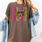 A woman wearing a brown t-shirt with a graphic of a tiger's face and the text "WILDCATS" printed on it.