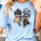 a woman wearing a blue shirt with a patriotic bow on it
