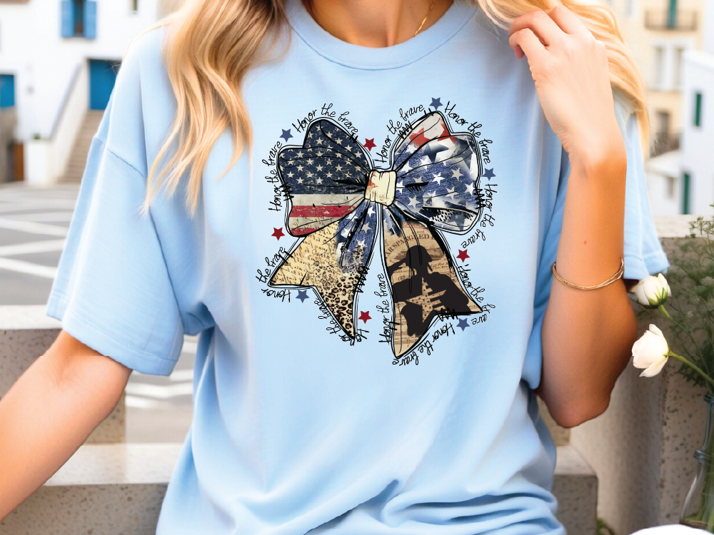 a woman wearing a blue shirt with a patriotic bow on it