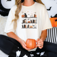 a woman sitting on a bed holding a pumpkin mug