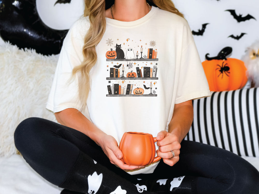 a woman sitting on a bed holding a pumpkin mug