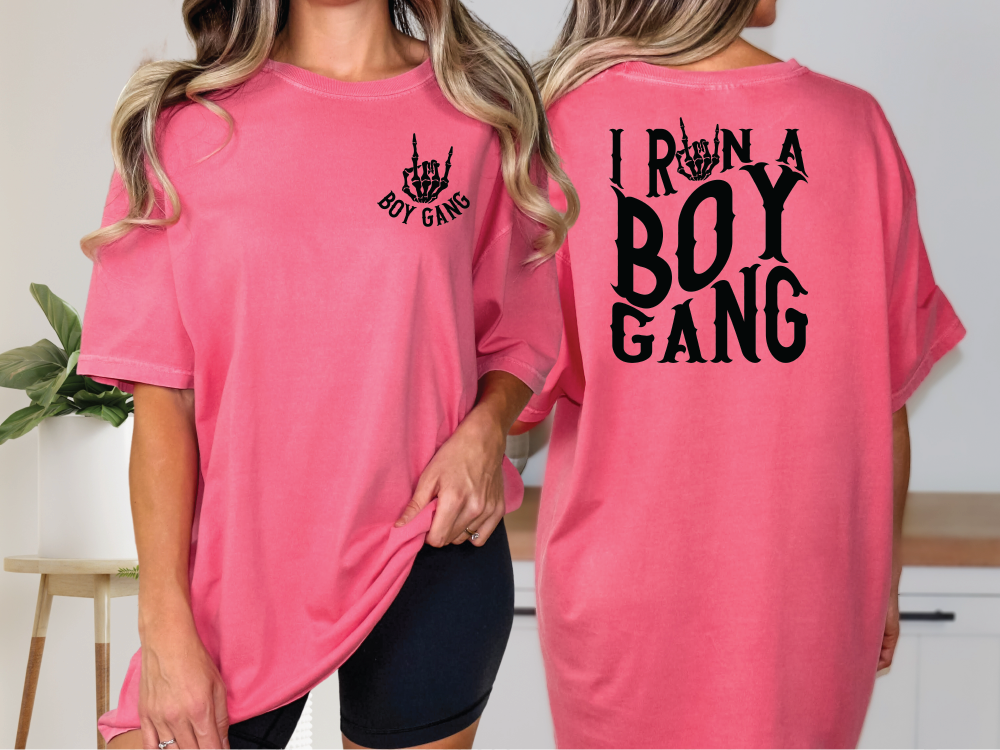 two women wearing pink shirts that say i run a boy gang