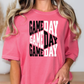 a woman wearing a pink game day t - shirt