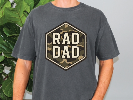 a man standing in front of a plant wearing a shirt that says rad dad