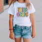 a little girl standing on a sidewalk wearing a white shirt