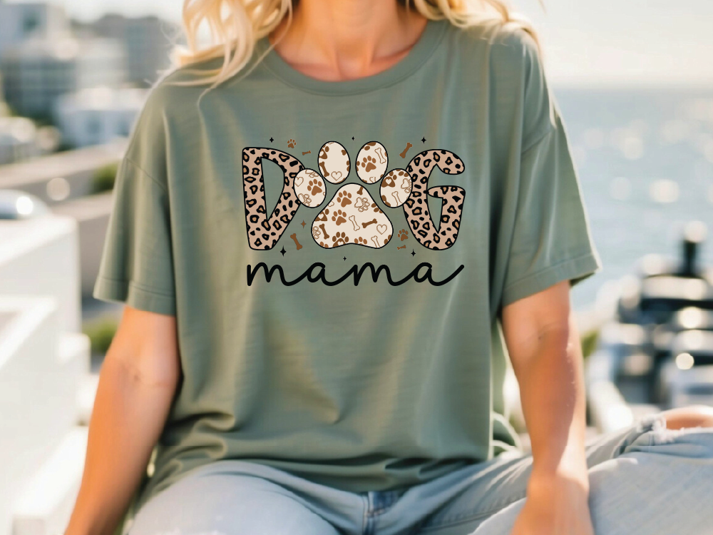 a woman sitting on a bench wearing a shirt with a dog's paw on