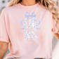 A woman wearing a pink t-shirt with the text "LESS THAN 500" printed on it.